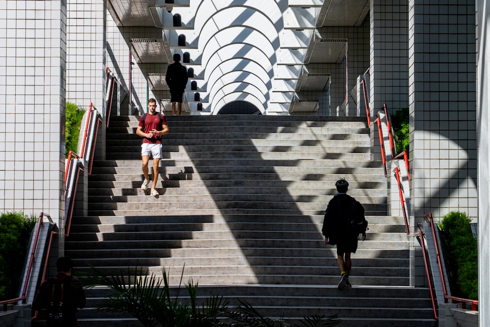 a couple of people that are walking down some stairs