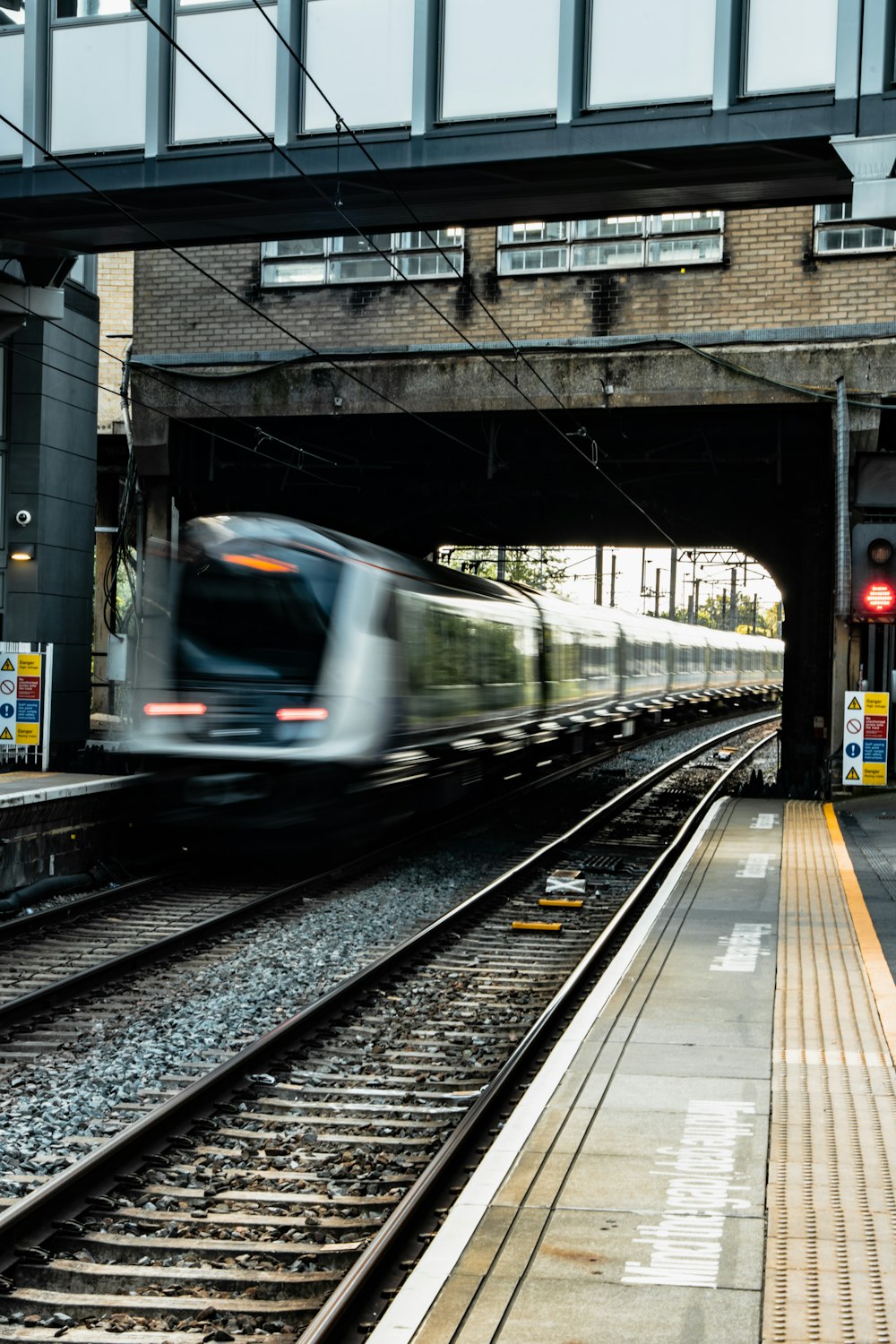 a train traveling through a train station under a bridge