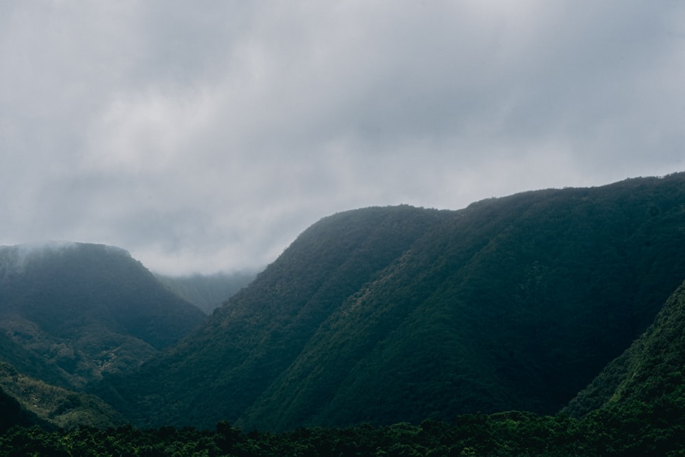 a view of a mountain range with a cloudy sky