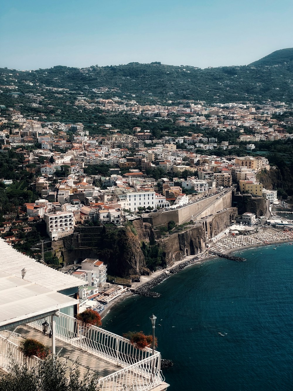 an aerial view of a city next to a body of water