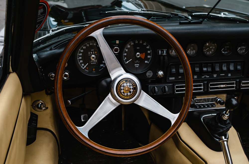 the interior of a car with a steering wheel and dashboard