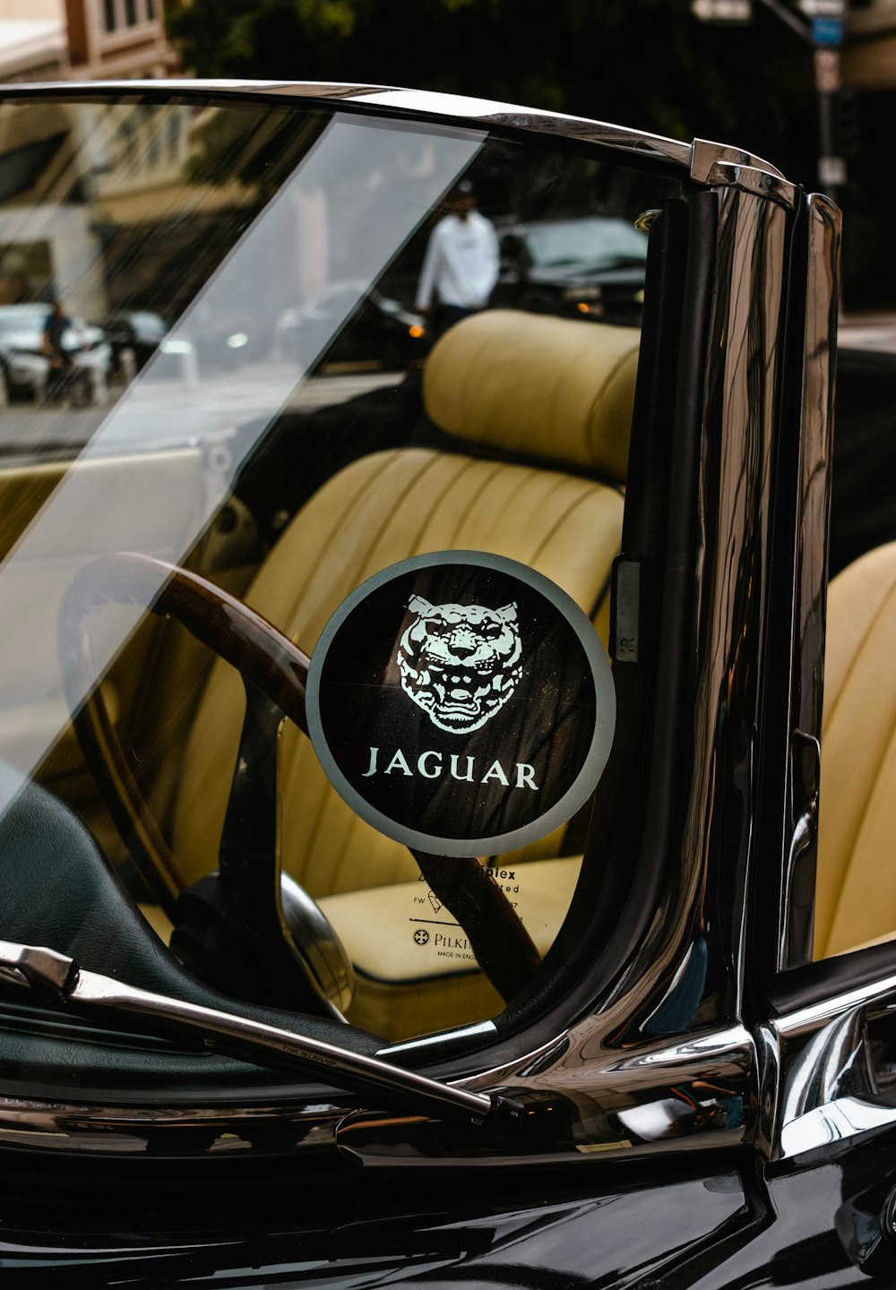 a car with a steering wheel and a jaguar emblem on it