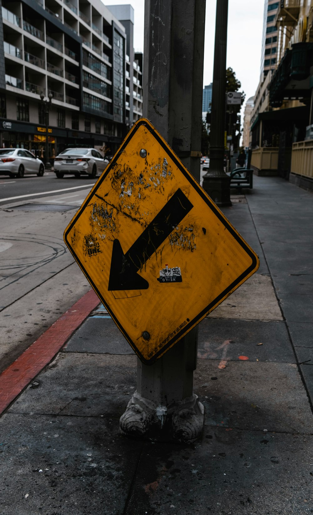 a yellow street sign sitting on the side of a road