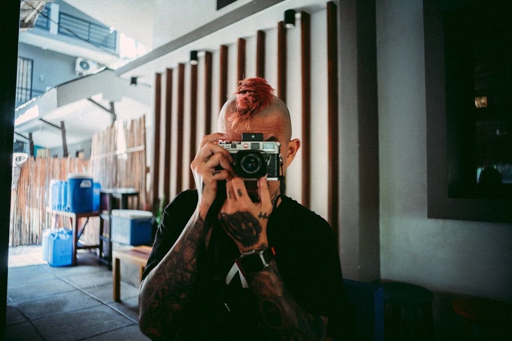 a man taking a picture of himself with a camera