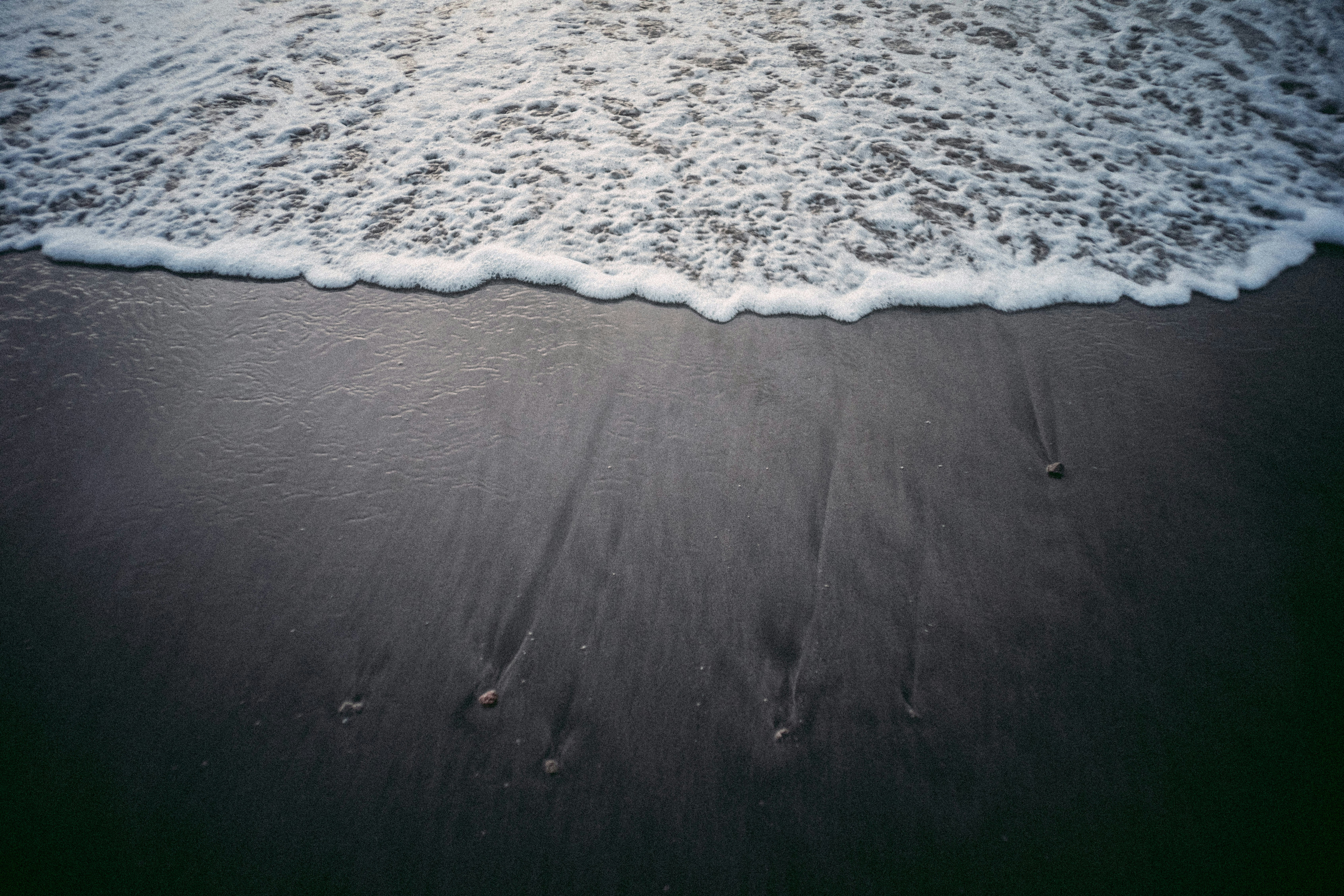 two footprints in the sand on a beach