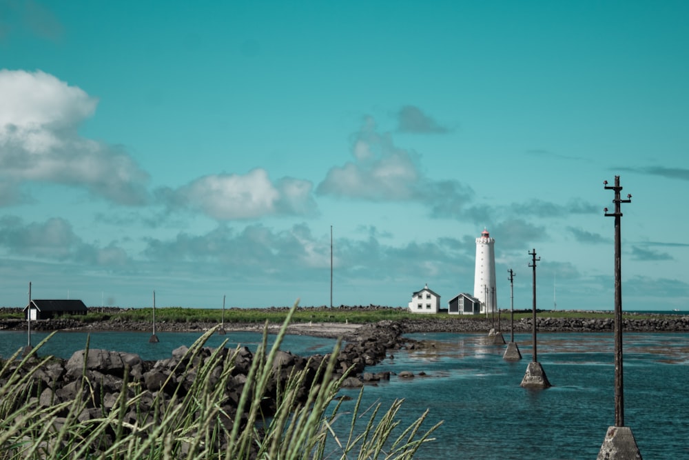 a light house sitting on top of a body of water