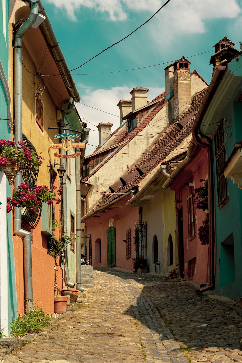 a cobblestone street lined with colorful buildings
