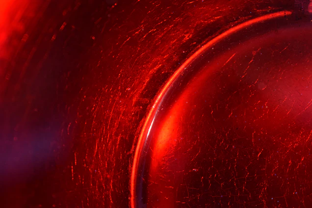 Close-up of a vibrant scratch art piece revealing detailed patterns beneath a black surface.