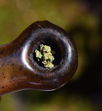 Close-up of the Sweet Puff pipe showcasing its clear borosilicate glass and smooth curves on a reflective black surface.