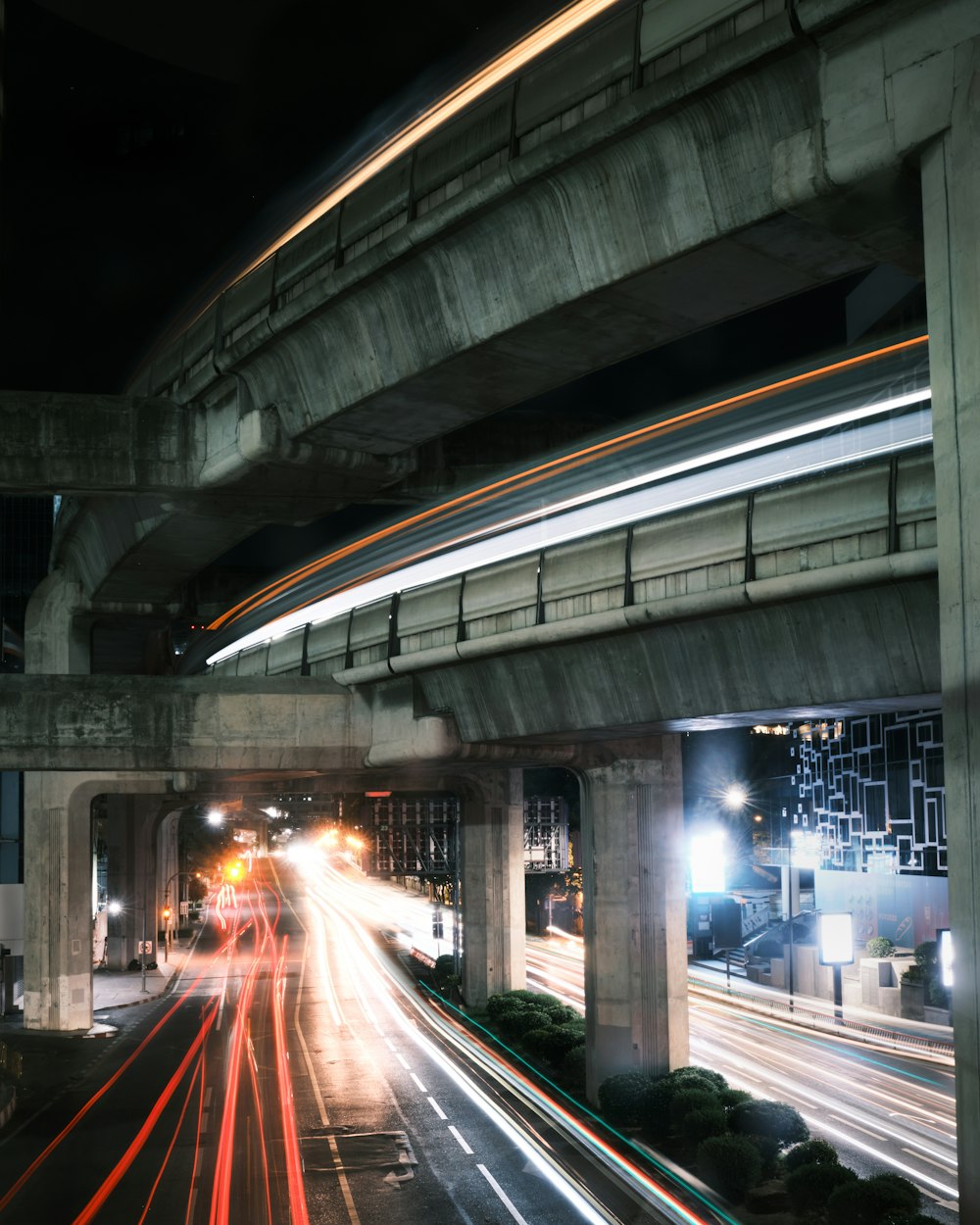 a long exposure photo of a highway at night