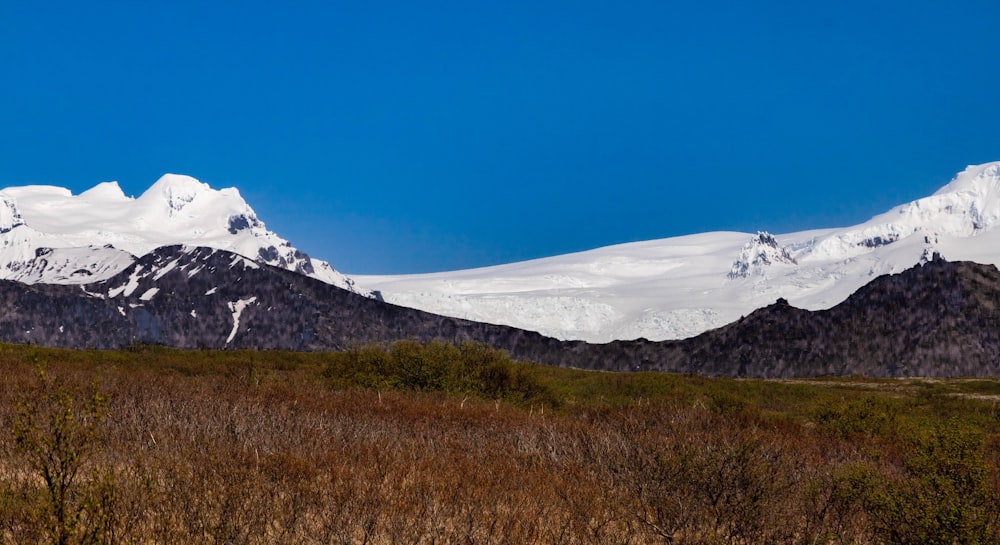 a snow covered mountain range in the distance