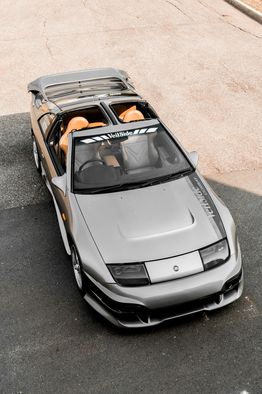 a silver sports car parked in a parking lot