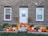 A charming entrance featuring stacked pumpkins in different sizes and hues.