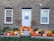 A charming entrance featuring stacked pumpkins in different sizes and hues.