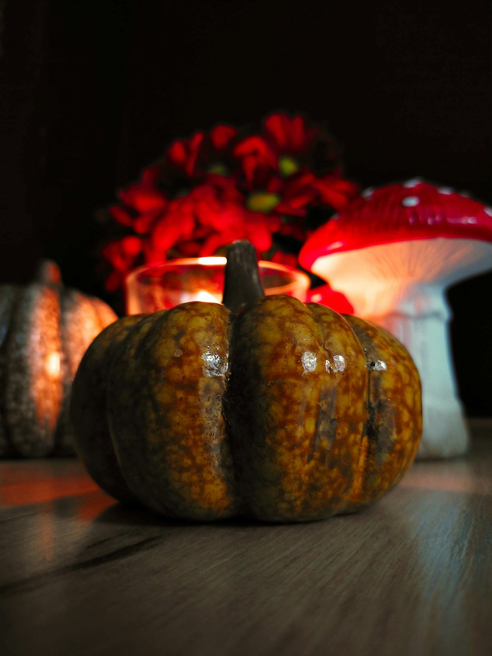 a couple of pumpkins sitting on top of a wooden table