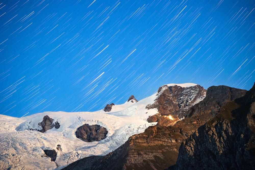 a snow covered mountain with stars in the sky