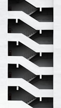 a black and white photo of a staircase in a building