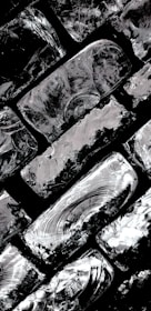 Close-up of textured brushstrokes revealing the intricate play of light and shadow in a Luberon village scene.