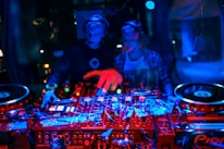 A group of diverse DJs collaborating in a modern studio environment.