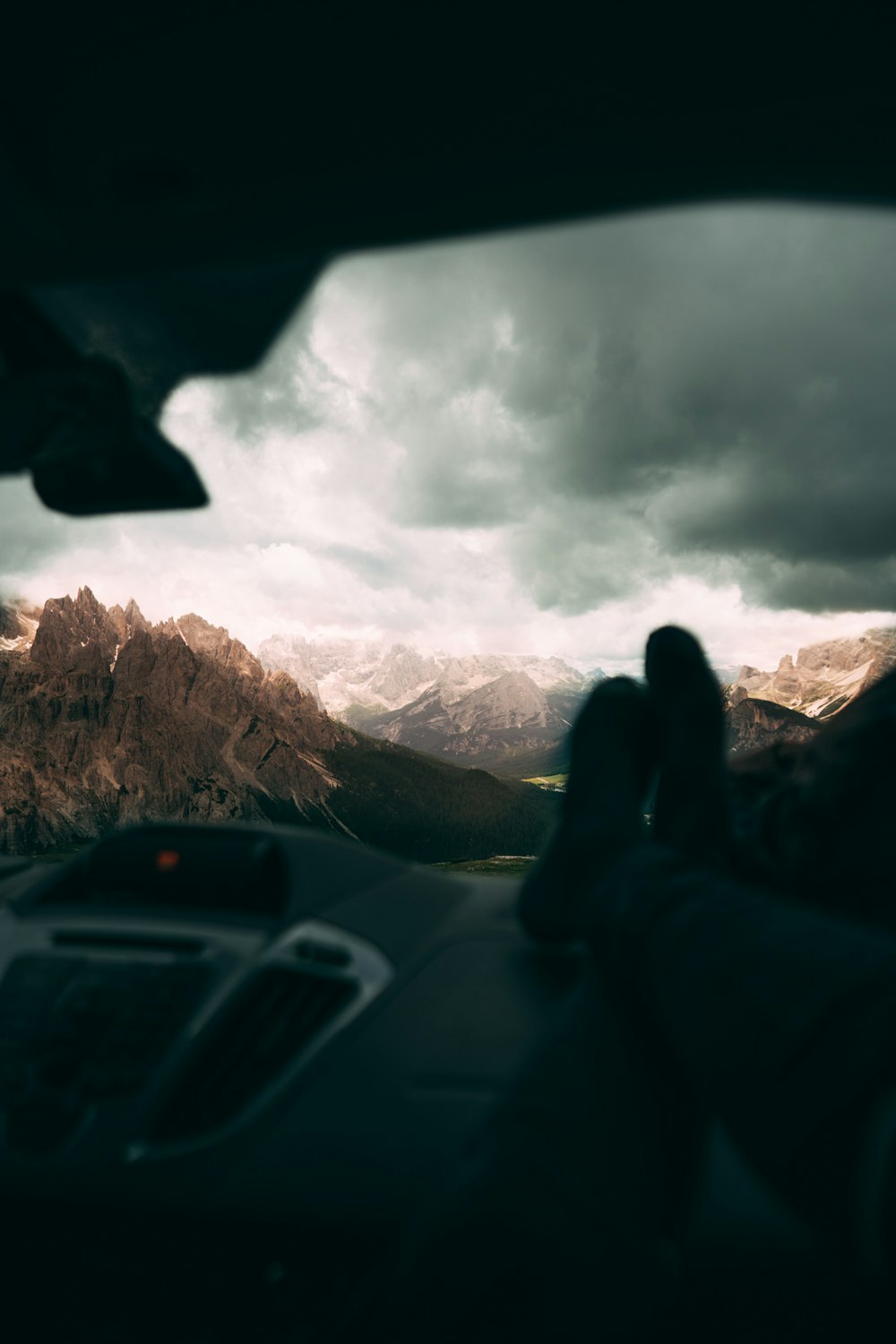 a view of a mountain range from inside a car