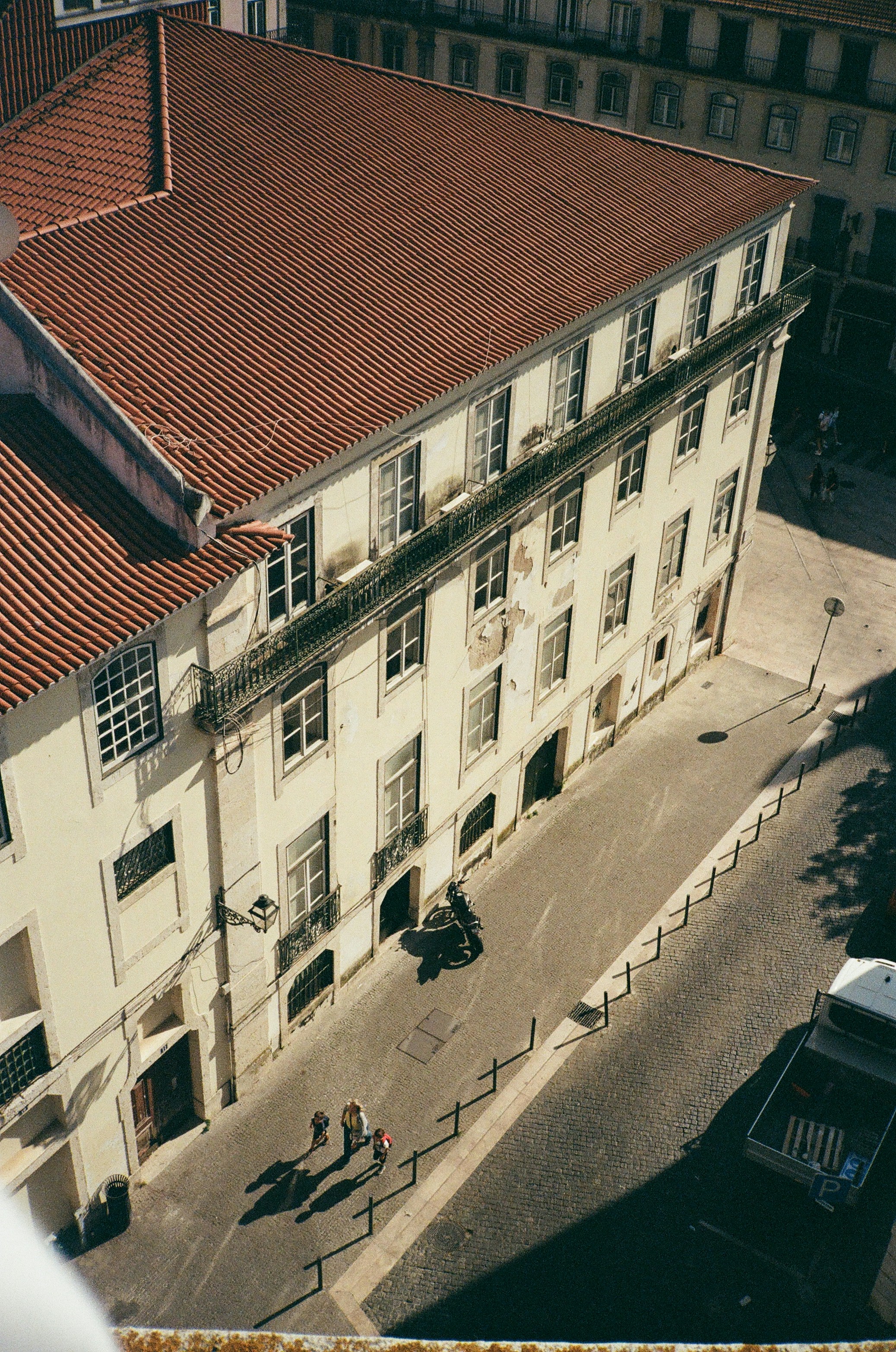 an aerial view of a building with a red roof