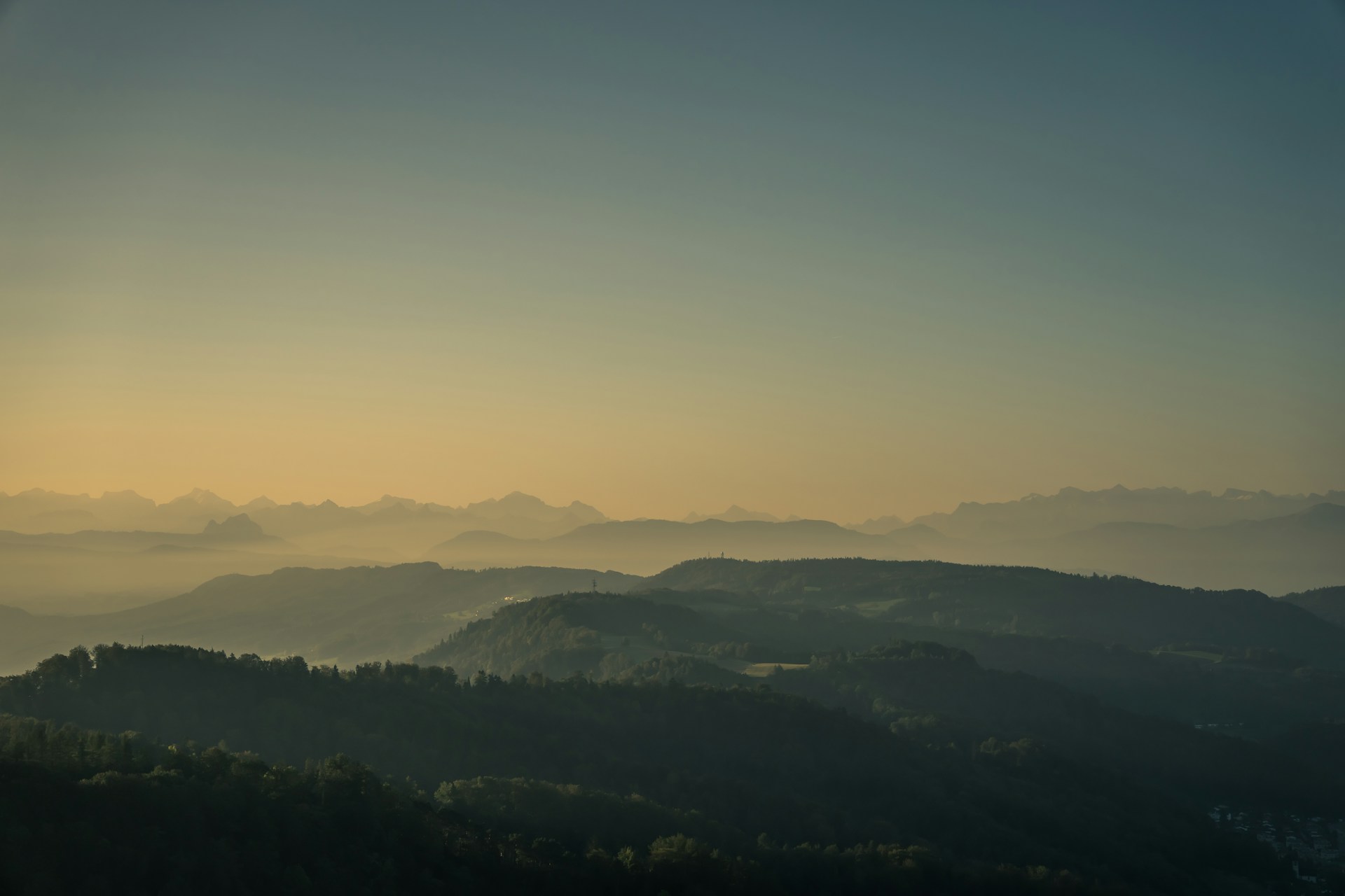 A serene landscape painting capturing soft morning light over rolling hills.