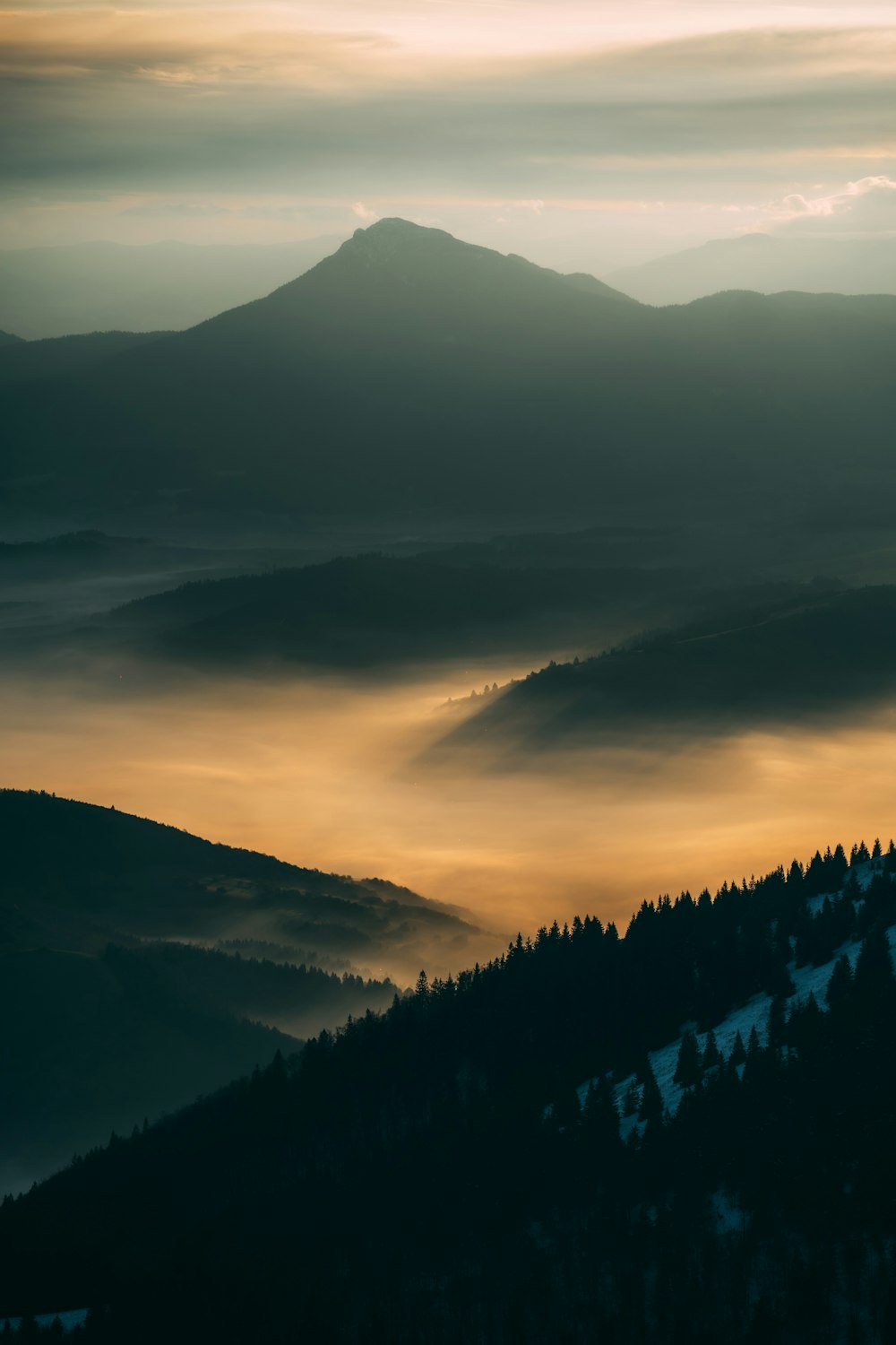 a view of a mountain range covered in fog