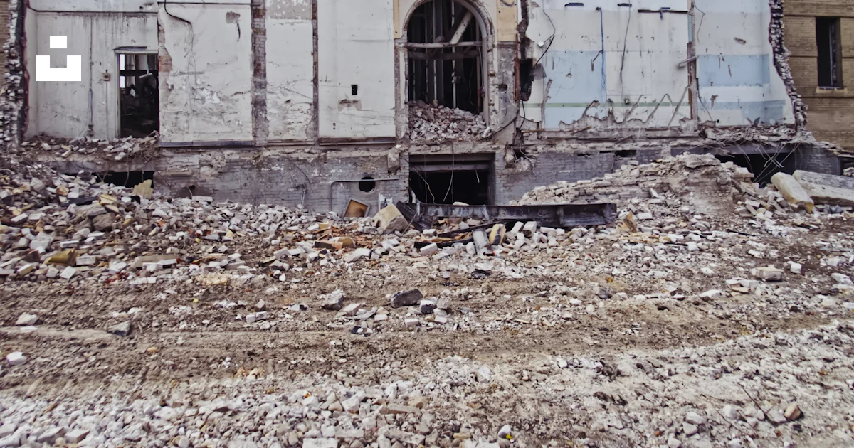 Rubble Running A run down building with a bunch of rubble in front of it photo – Free ...