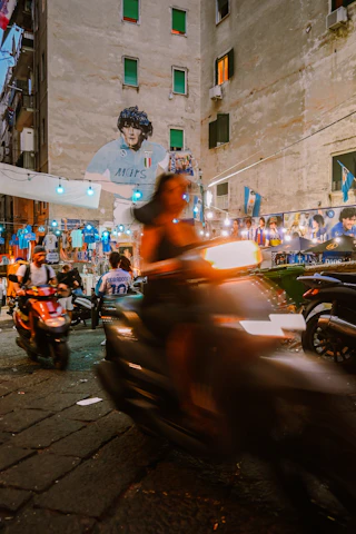 A vibrant street football match in Cartagena with local musicians playing in the background under colorful banners.