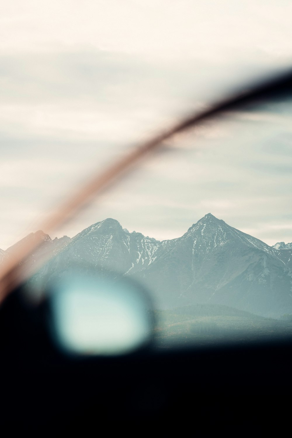 a view of a mountain range from inside a vehicle
