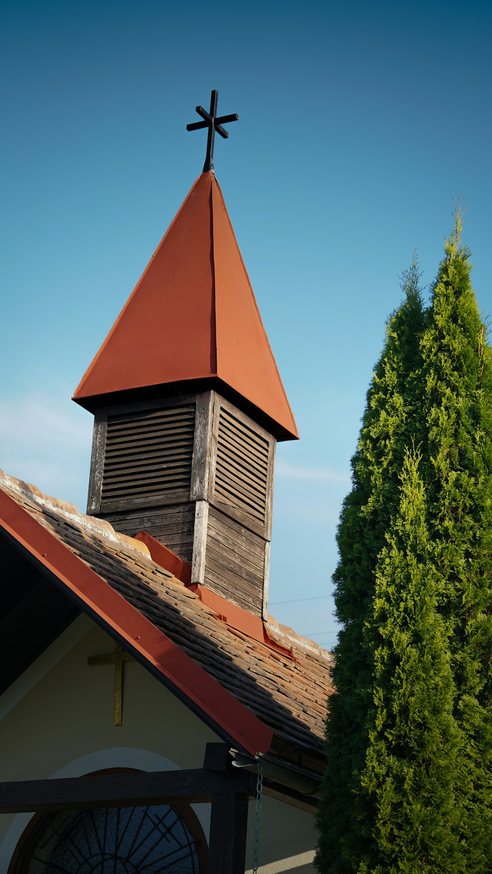 a church steeple with a cross on top