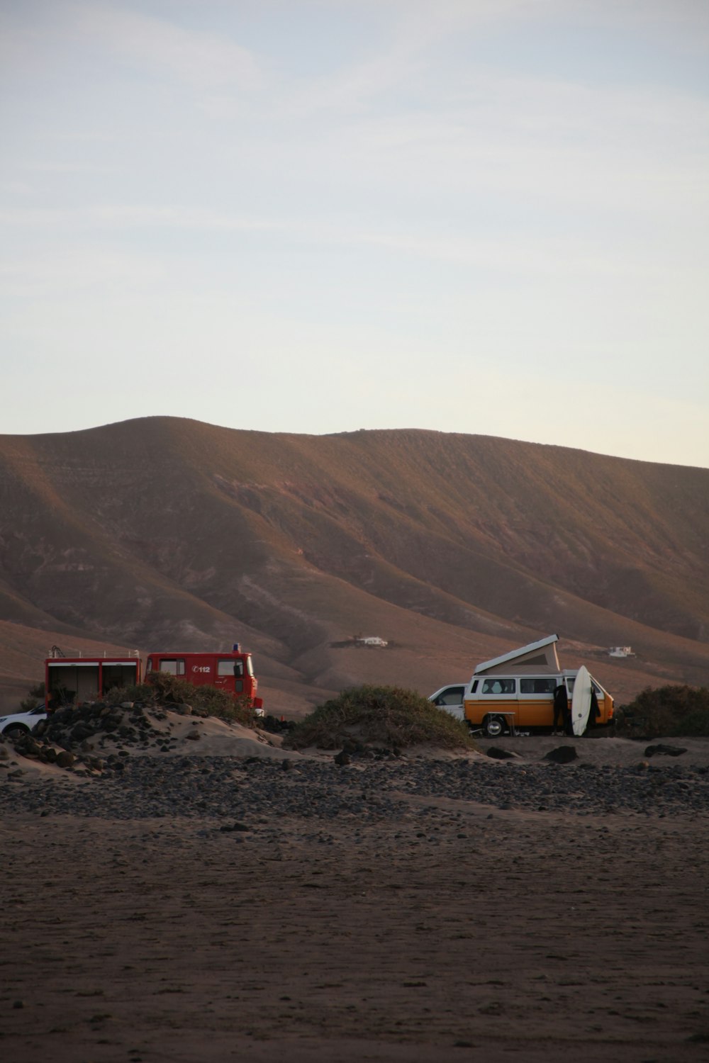 a van is parked in the middle of a desert