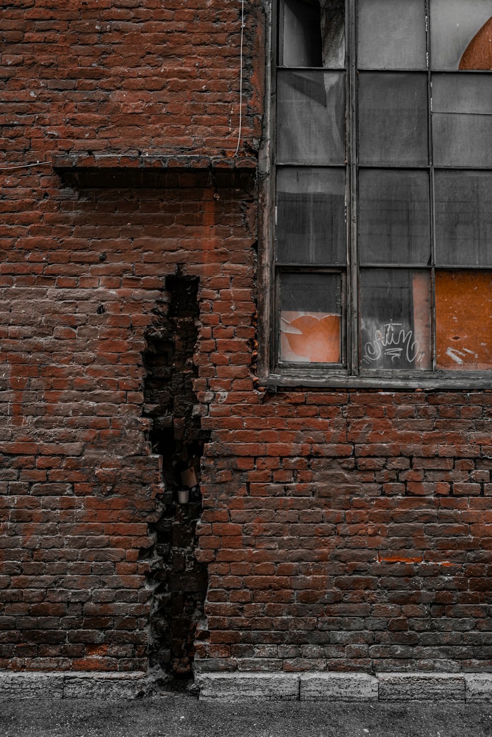 a red brick building with a broken window