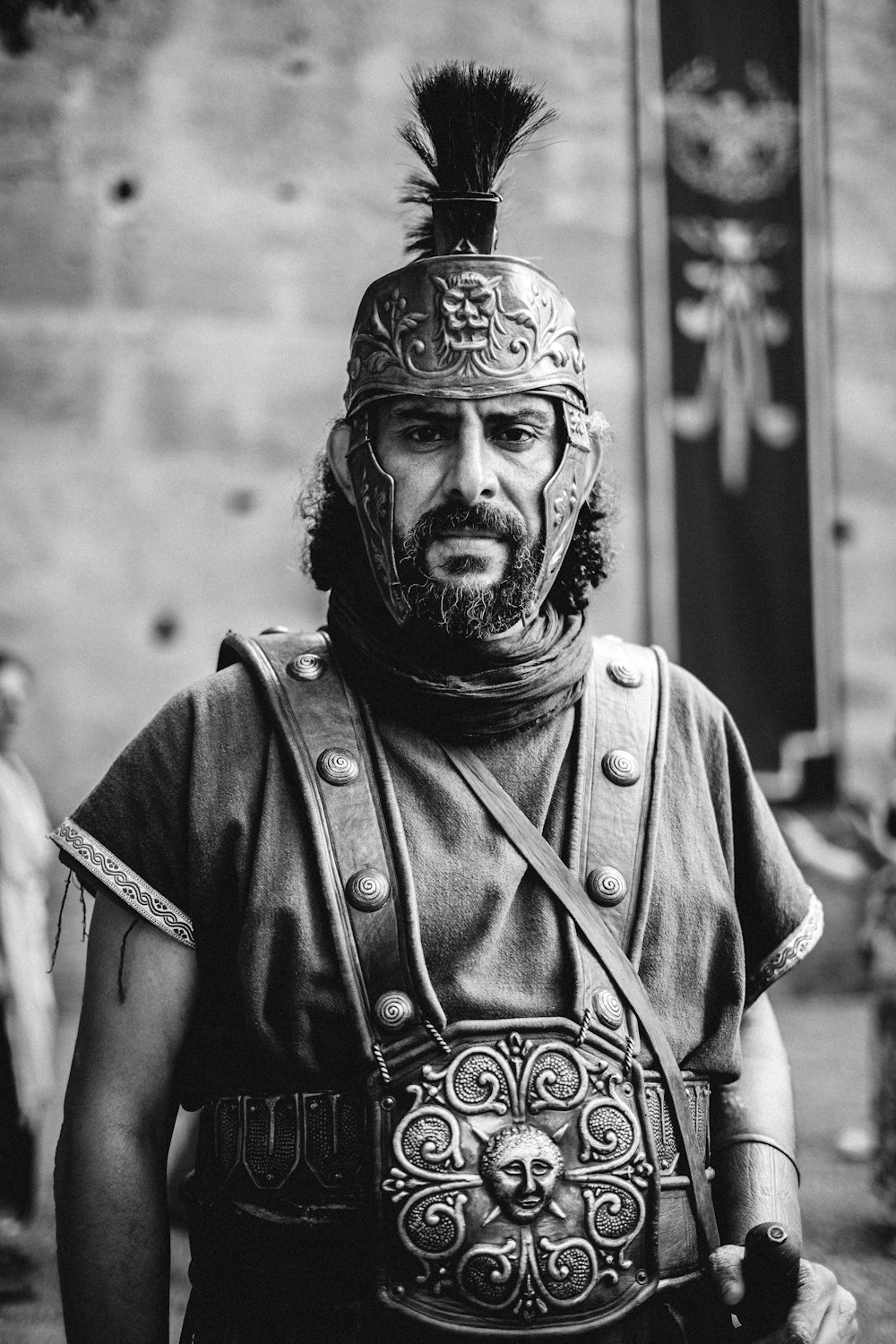 a black and white photo of a roman soldier