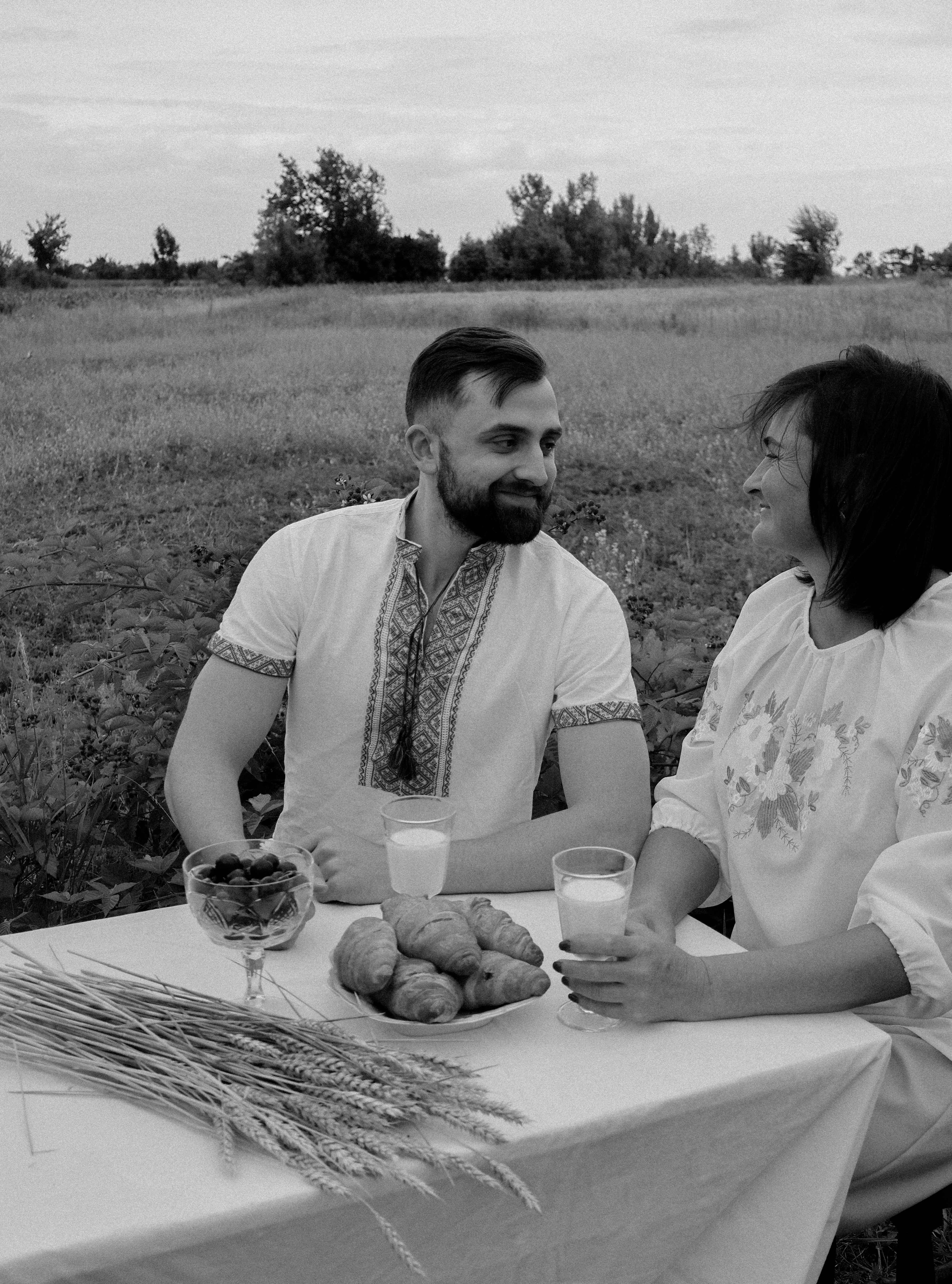 Traditional family meal being shared together with hosts and guests in authentic village setting