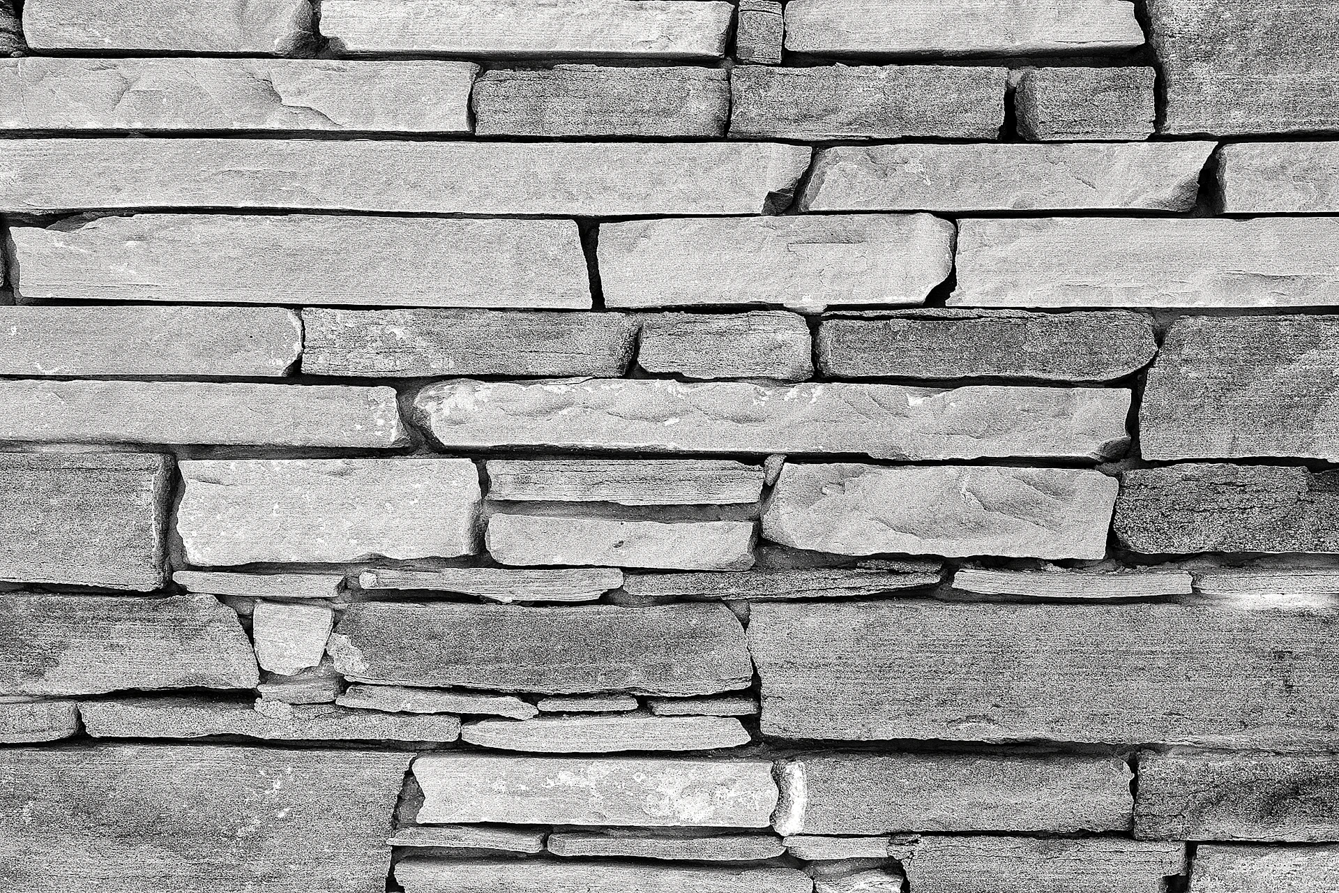 a black and white photo of a stone wall