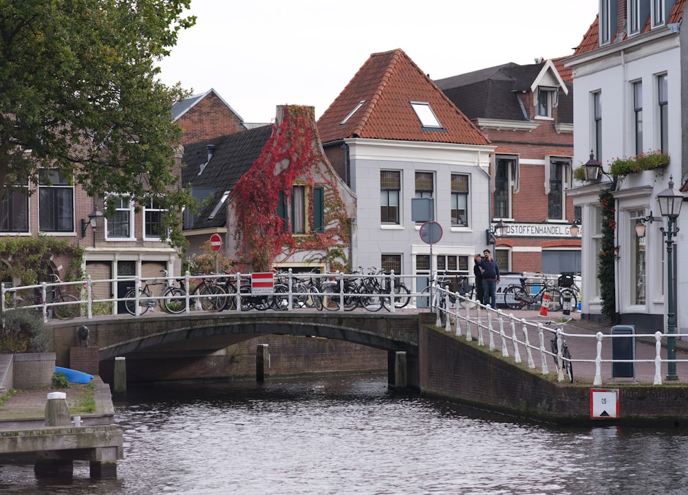 a bridge over a body of water with buildings in the background