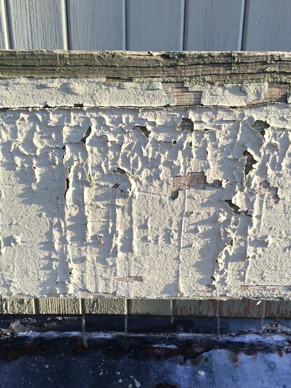 a close up of a wall with peeling paint