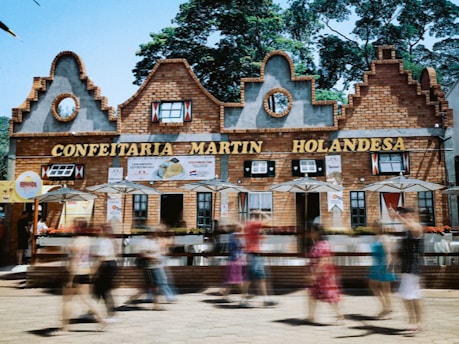 a blurry photo of people walking in front of a building