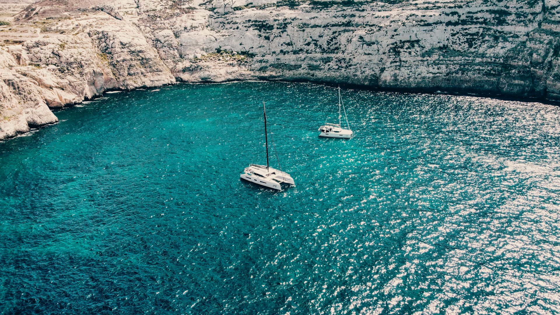 a couple of boats floating on top of a body of water