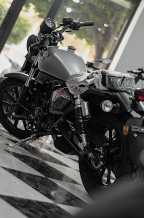 A sleek motorcycle on display in the Ride On Pakistan showroom with bright lighting