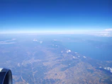 A serene view from the airplane window showing the vast Indian landscape below.