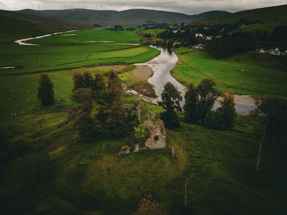 an aerial view of a river running through a lush green countryside