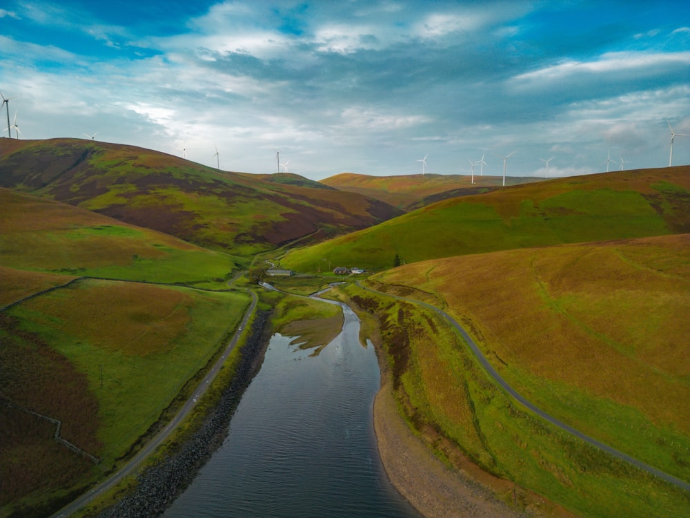 a river running through a lush green hillside