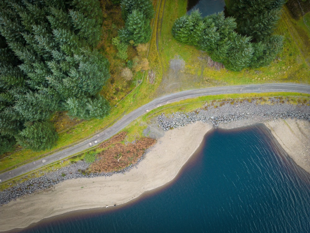 an aerial view of a road and a body of water