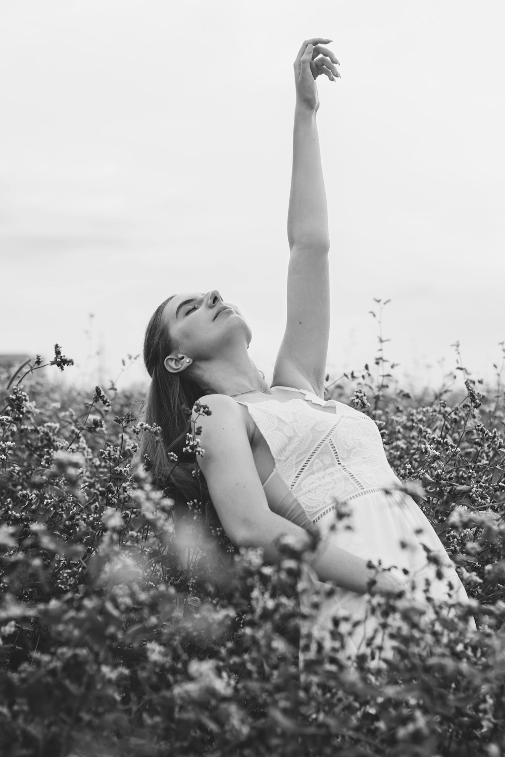 a woman laying down in a field of flowers