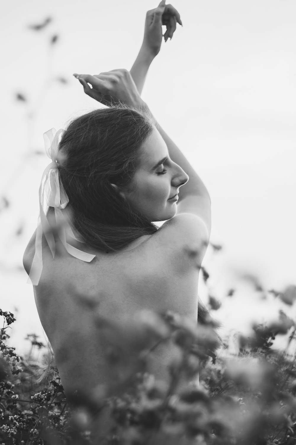 black and white photograph of a woman in a field