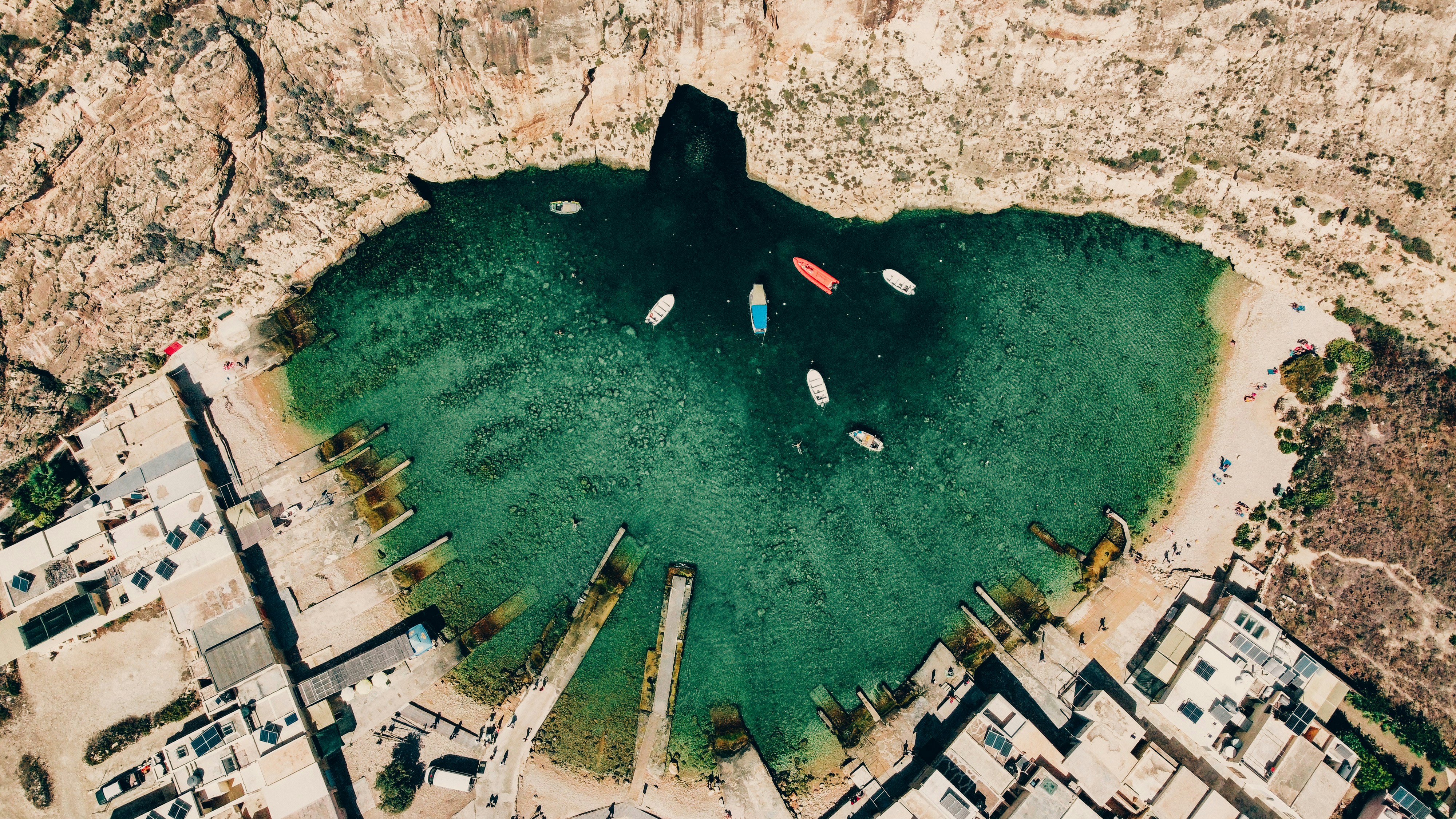 a group of boats floating in a lake surrounded by mountains