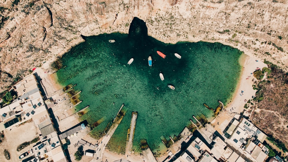 a group of boats floating in a lake surrounded by mountains