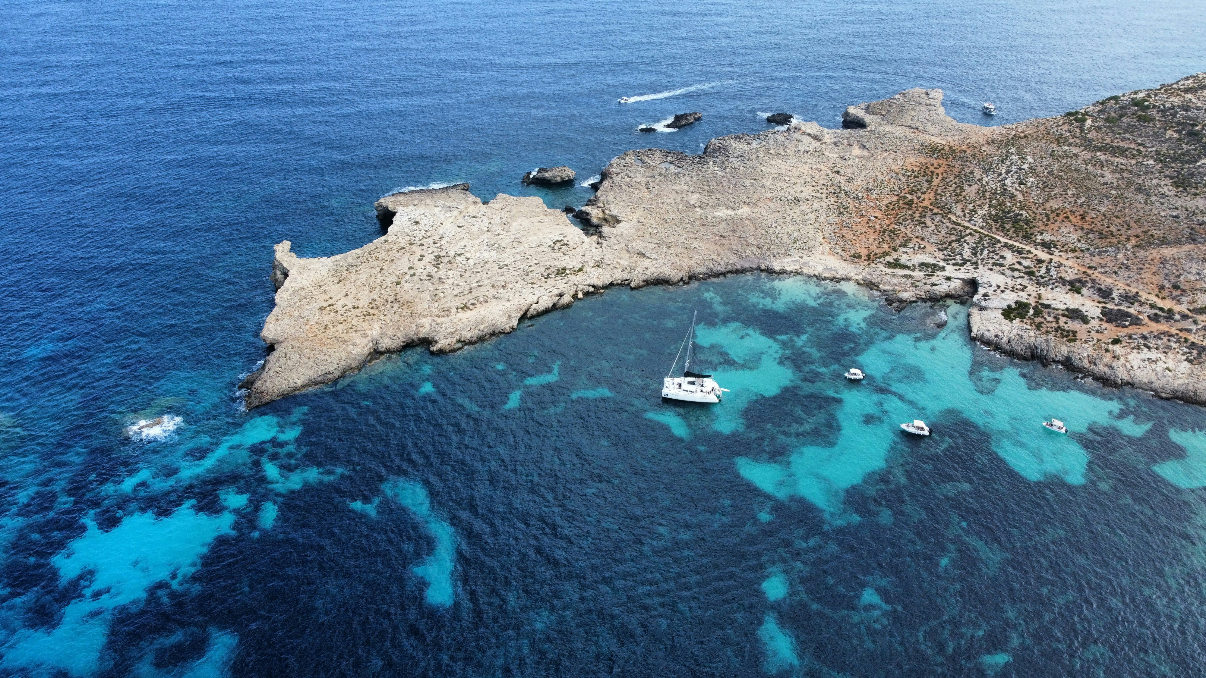 a group of boats floating on top of a body of water